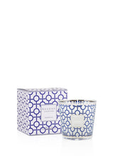 Candle with decorative box featuring a blue geometric pattern on a white background