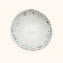 Ceramic bowl with decorative patterns on a white background