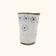Spako Clay tumbler with blue floral patterns on a white background