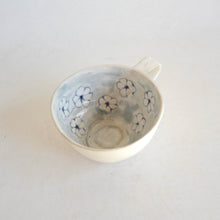 Cappuccino mug with blue flower pattern on beige background