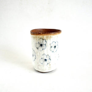Ceramic cup with floral patterns on a white background