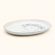 White ceramic plate with blue floral design on a white background