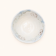 Round ceramic bowl with floral design on a white background