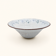 Ceramic bowl with textured surface on a white background