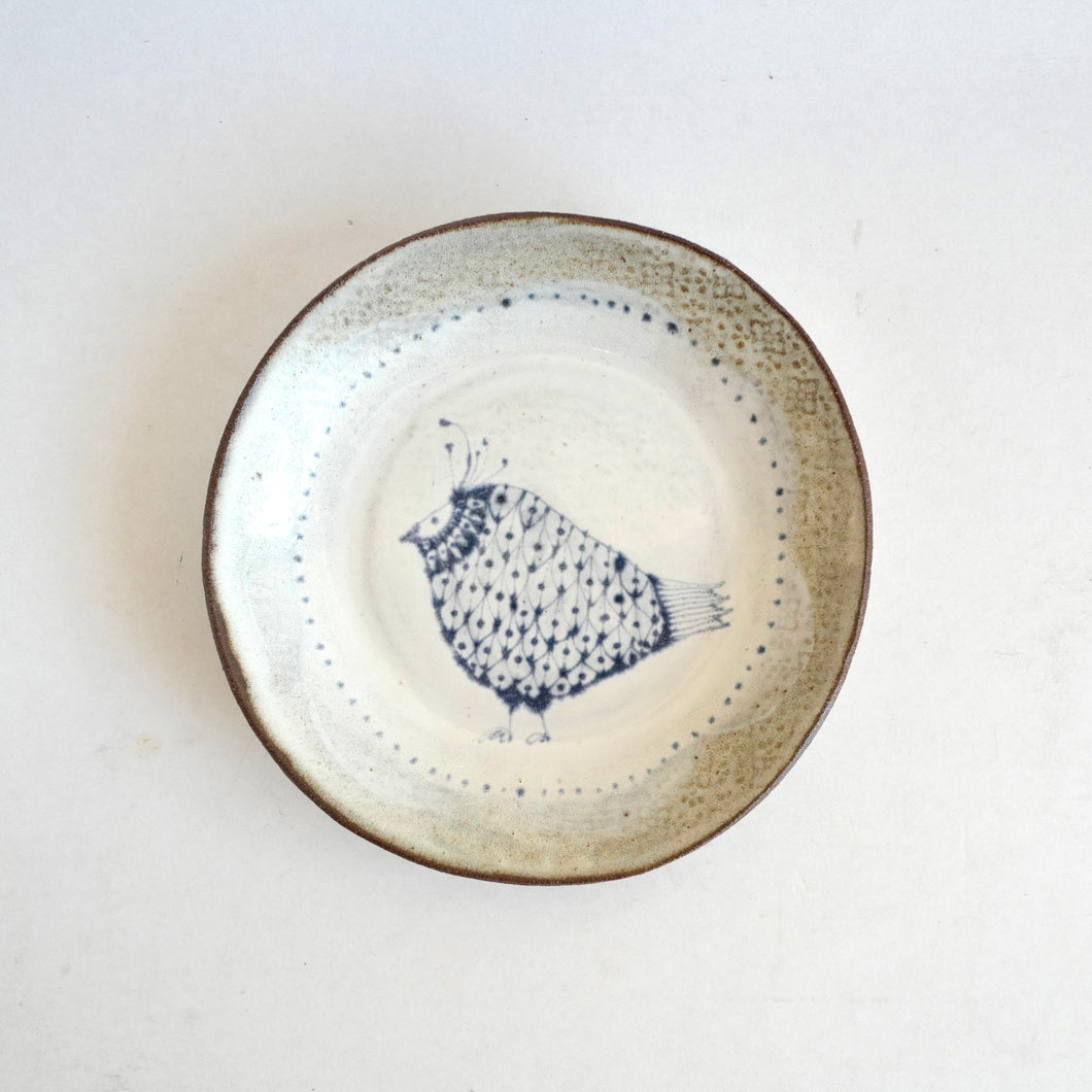 Ceramic plate with a bird design on a white background