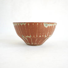 Ceramic bowl with a unique glaze pattern on a white background