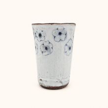 Spako Clay tumbler with blue floral patterns on a white background