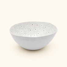 White ceramic bowl with floral pattern on a white background