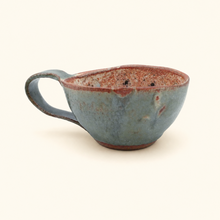 Ceramic cup with a textured surface on a white background