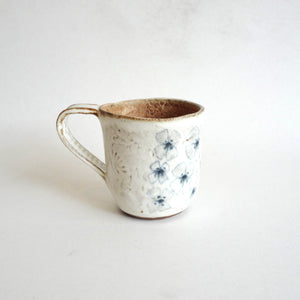 Spako Clay mug.  Blue line flower drawing, white glaze