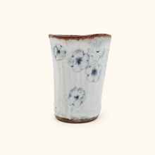 Spako Clay tumbler with blue floral patterns on a white background
