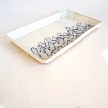 Rectangular ceramic tray with decorative blue pattern on a white background