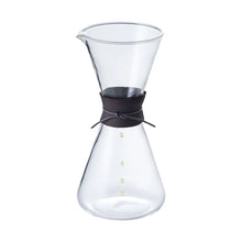 Clear glass coffee maker with deer skin  band on a white background