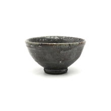 Black ceramic bowl on a white background