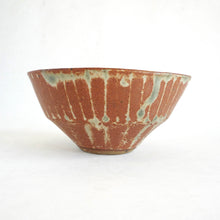 Ceramic bowl with a textured surface on a white background