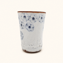 Spako Clay tumbler with blue floral patterns on a white background