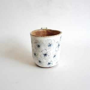 Spako Clay mug.  Blue line flower drawing, white glaze