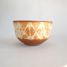 Ceramic bowl with decorative patterns on a white background