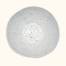 Round ceramic bowl with floral pattern on a white background