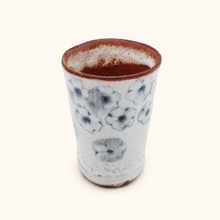 Spako Clay tumbler with blue floral patterns on a white background