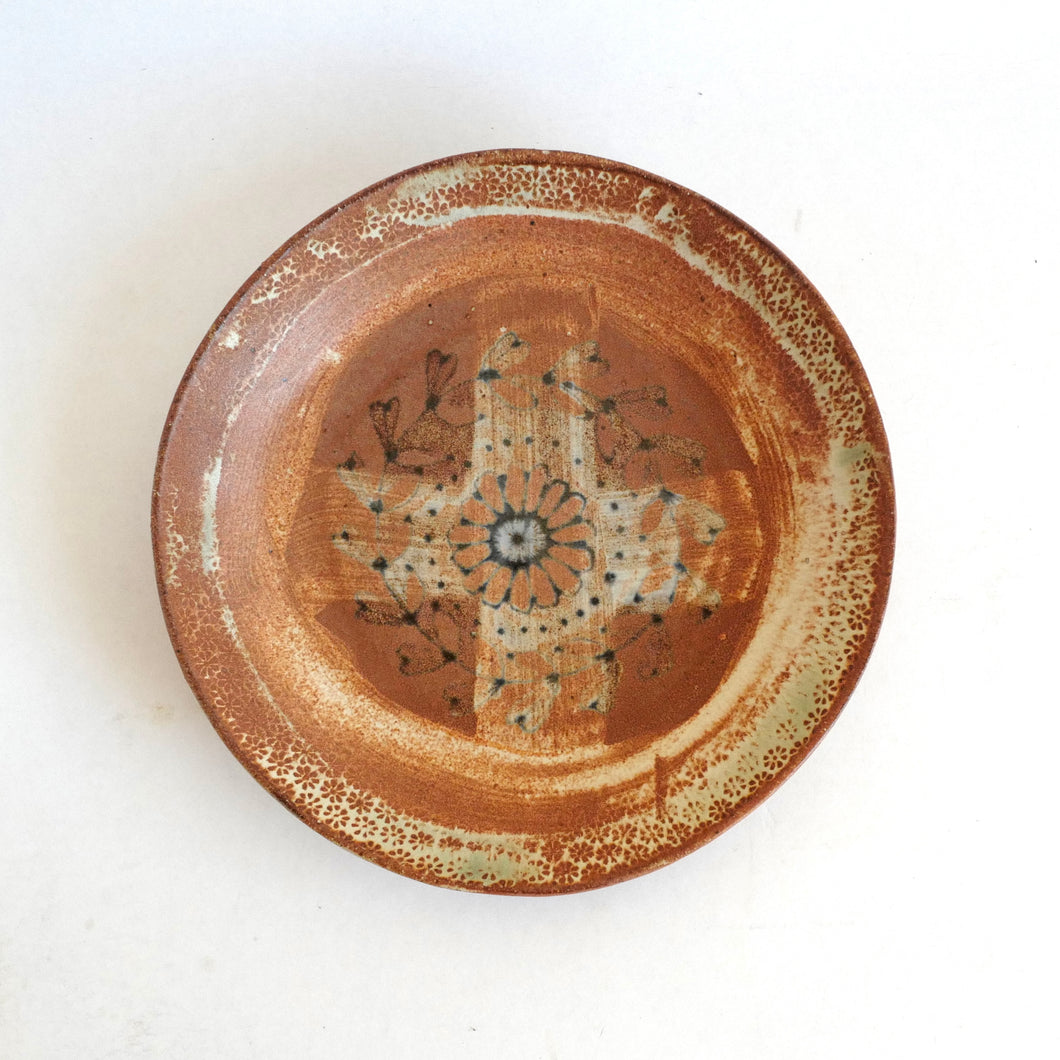 Ceramic plate with decorative design on a white background