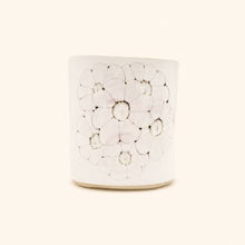 White ceramic vase with floral design on a white background