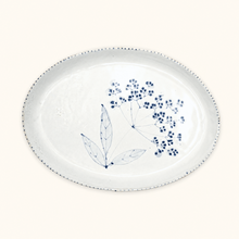 White ceramic plate with blue floral design on a white background