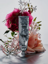 Tube of Flamingo Estate skin cream with flowers on a light background