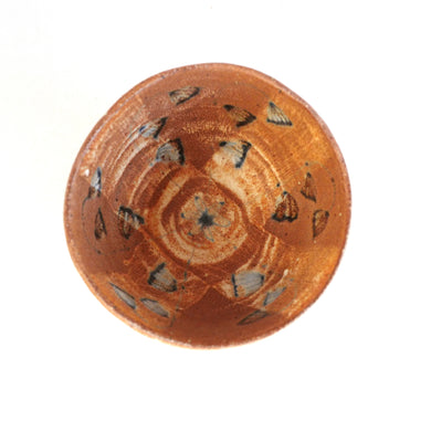 Ceramic bowl with decorative patterns on a white background