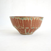 Ceramic bowl with striped pattern on a white background