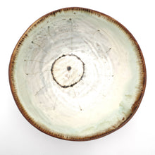 Ceramic bowl with a textured surface on a white background
