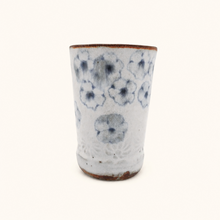 Spako Clay tumbler with blue floral patterns on a white background