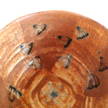 Ceramic plate with floral patterns on a brown background