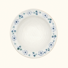 White ceramic plate with blue floral pattern on a white background
