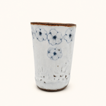 Spako Clay tumbler with blue floral patterns on a white background