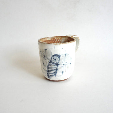 Spako Clay mug. Blue line bee drawing, white glaze