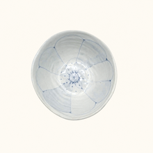White ceramic bowl with blue floral pattern on a white background