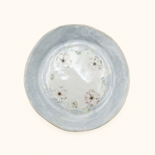 Ceramic plate with floral patterns on a white background