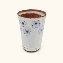 Spako Clay tumbler with blue floral patterns on a white background