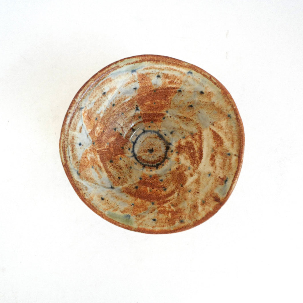 Ceramic bowl with a unique pattern on a white background