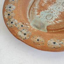 Ceramic plate with floral patterns on a white background