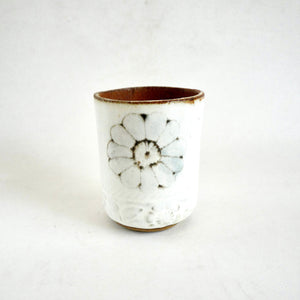 Ceramic cup with floral design on a white background