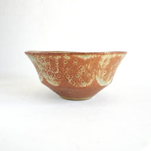 Ceramic bowl with textured surface on a white background
