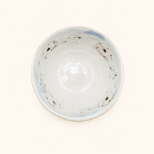 Small ceramic bowl with a floral design on a white background