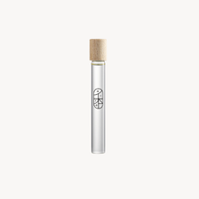 Perfume roll-on vial with wood cap on white background