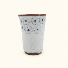 Spako Clay tumbler with blue floral patterns on a white background