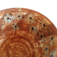 Close-up of a ceramic bowl with floral pattern on a white background