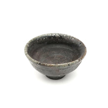 Black ceramic bowl on a white background