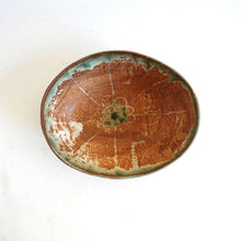 Ceramic plate with brown and green glaze on a white background