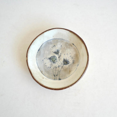 small plate with  blue daisies pattern on white background